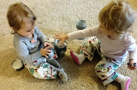 Girls playing with cans